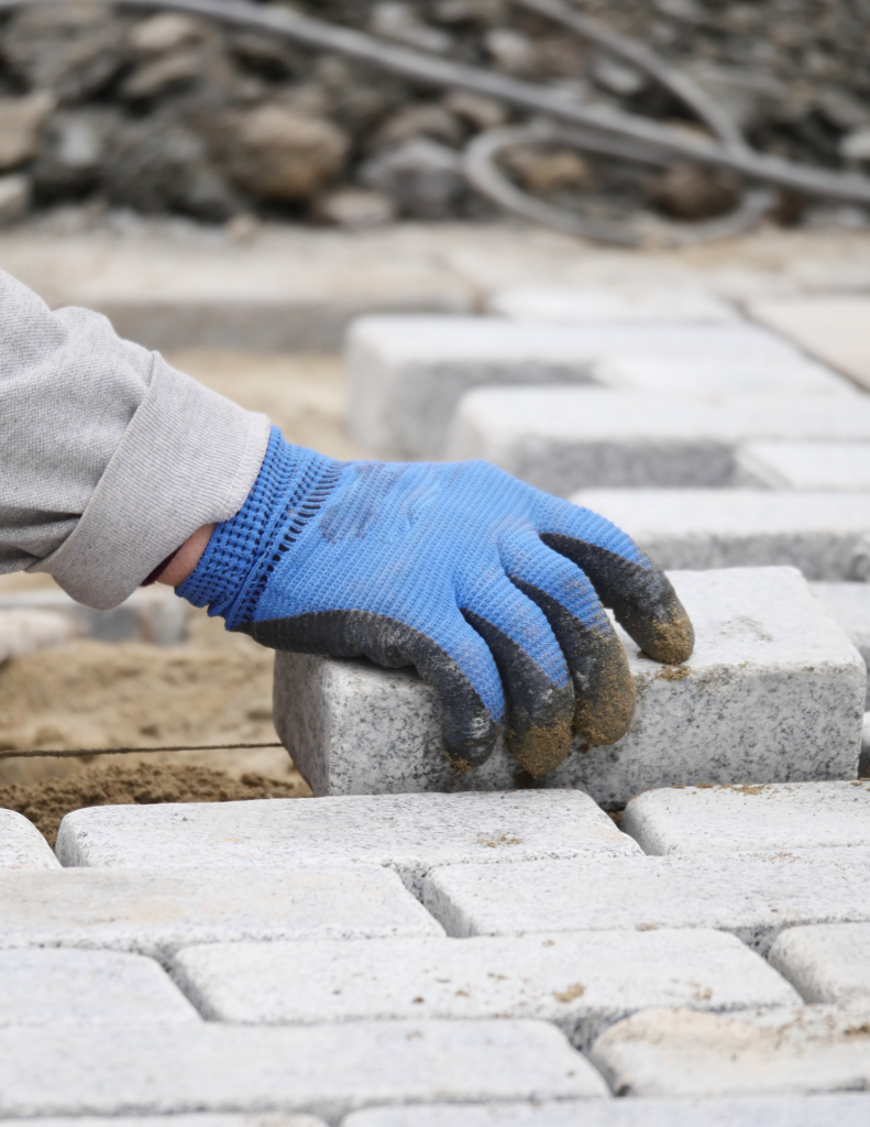 Laying down bricks for pathway in landscape design