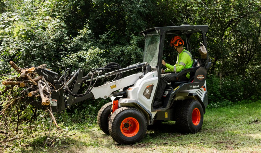 Bobcat with front hydraulic grabbing arm